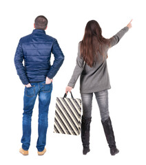 back view of couple with shopping bags in winter jacket.