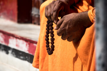 Image of an Indian sadhu sitting in a meditation pose with rudraksha