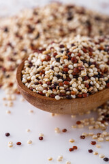 mix of quinoa grains on white acrylic background