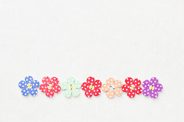 Creative background with decorative wooden buttons shaped like flowers