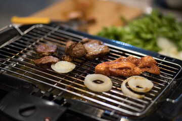 Korean BBQ. Korean BBQ Raw Beef on the Grill. grilled raw pork. Korean barbecue or yakiniku style. Beef bbq Japan. Raw beef slice for barbecue or Japanese style yakiniku