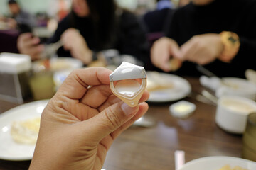 Asian woman hands fresh milk in a cup
