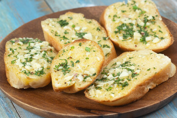 Garlic bread on the wooden plate