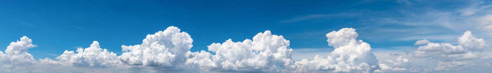 Naklejka na ściany i meble White fluffy clouds on blue sky. Soft touch feeling like cotton. White puffy clouds cape with space for text. Beauty in nature. Close-up white cumulus clouds texture background. Sky on sunny day.
