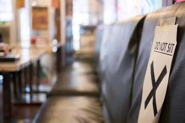 Social distancing seating in restaurant for prevent risk of transmission Covid-19. Close-up view of the 