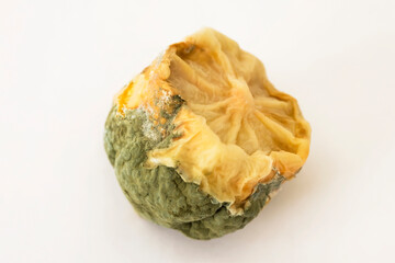 Old lemon with mold. Macro photo. The lemon has gone bad. Lemon is rotten. Texture of mold and fibers of an old lemon. Lime peel is moldy. White background