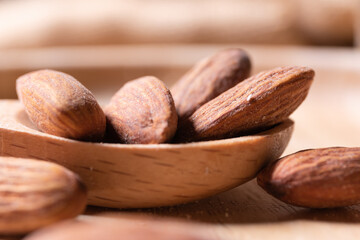 Delicious looking almonds on a wooden spoon