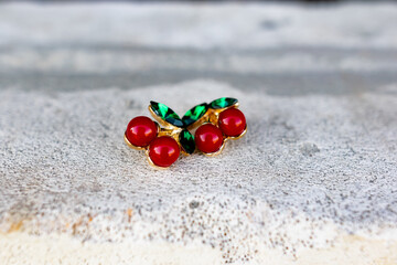 Cute little brooches in the form of red cherries with green leaves made of emerald green stones. Combined with various elements of nature.