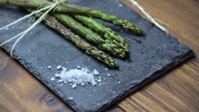 Esp&aacute;rragos verdes o trigueros a la plancha sobre una pizarra con sal gorda