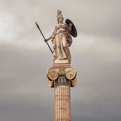 Athena goddess marble statue with spear and shield isolated on grey sky background