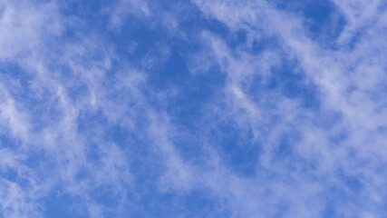 Blue sky background with white clouds on sunny day.