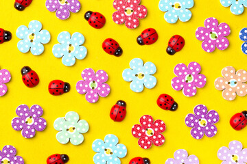Bright creative background with decorative wooden buttons and ladybugs