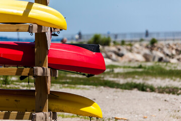 Close up from kayaks in wooden stand outside near water