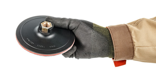 Angle grinder quick release holder for sanding paper discs in worker hand in black protective glove and brown uniform isolated on white background