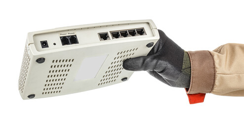 Male hand in black protective glove holding VoIP gateway with connection ports on back panel isolated on white background