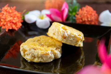 Two Scone are on the black dish