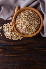 raw oatmeal on a wooden rustic background