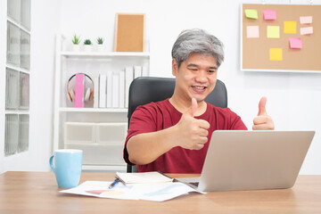 Asian businessman video conference calling on laptop computer talk by webcam for an online learning education course at home. Concept of online education evening study.