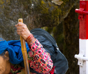 Image of old women walking with the support of stick at mountain region