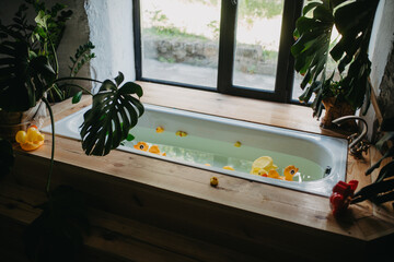 Kids toys floats in bathtub full of water for bathing a baby.