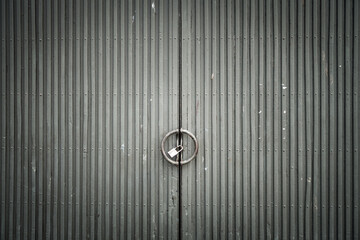 Grungy weathered grey metallic doors. Old weathered iron gate.