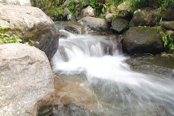 Fototapeta na wymiar Water flows on a small river