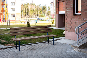 Bench near the entrance of a residential building.