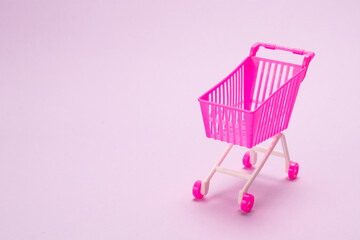 Blue present box with pink bow in a shopping cart