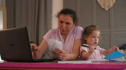 Financial crisis during Covid -19 period. Worried woman at home keeps the family budget. Accounting of monthly income and expenses (utility, bill, credit). Mother with child