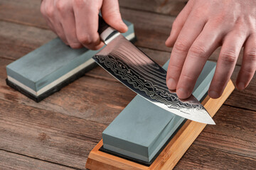 Man sharpens a Gyuto knife using a whetstone