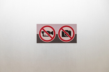 No photography and no video recording sign on glass door. restrict area.