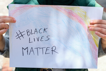 Child boy hold a paint draw for support black lives matter protest in USA, no racism 