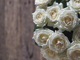 Floral card. Beautiful white rose on a wooden background.