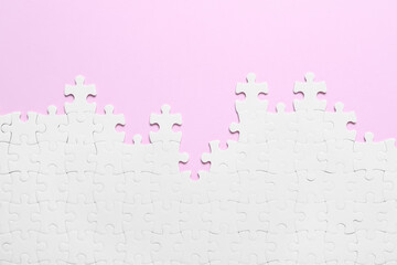 White puzzle on pink background, flat lay