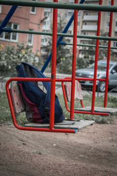 Backpack Lonely Sways On An Empty Swing Waiting For The Owner