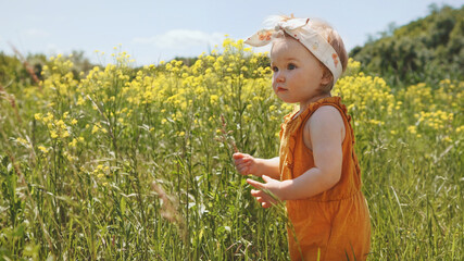 Child girl walking outdoor cute baby family travel vacations summer season nature rural rapeseed field grass