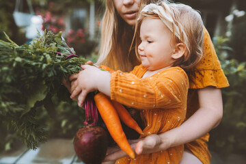 Family mother and child girl with organic vegetables healthy eating lifestyle vegan food homegrown...