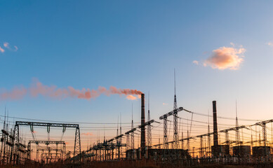 Thermal power stations and power lines during sunset.