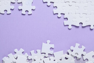 Blank white puzzle pieces on violet background, flat lay