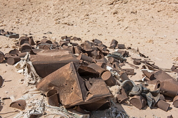 Old tin cans rubbish scattered in remote arid desert