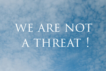 We are not a threat Sign with Dramatic Clouds and Sky.