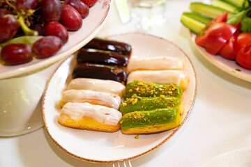 eclairs. catering. outdoor table with cakes. festive table. buffet.