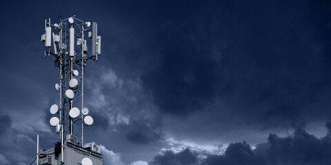 5G network transmitters on the roof of a skyscraper on a background of dramatic sky. 