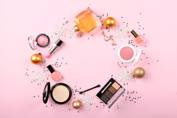 Beautiful composition with Christmas decor and makeup cosmetics on a colored background top view.
