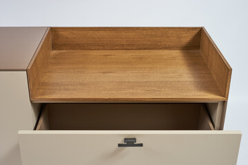 Details modern minimalistic TV stand coffee color with a decorative insert made of natural wood on a white background