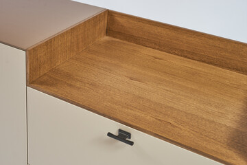 Details modern minimalistic TV stand coffee color with a decorative insert made of natural wood on a white background