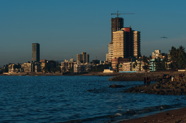 An evening by the beach: Tall Buildings standing by the seashore in Mumbai City