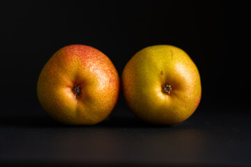 Two pears over black background.