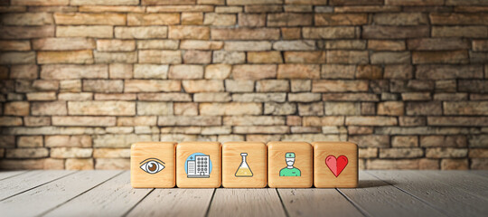 Fototapeta na wymiar cubes with health icons in front of a brick wall on a wooden floor