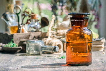 Magic potion bottles and dried plants on the witch doctor table. Witchcraft.